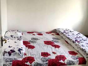 Freecycle Ikea king size bed frame with wooden slats and mattress.