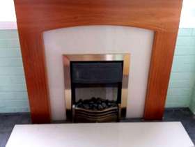 Freecycle Electric coal-like fire with marble and wood surround and hearth.