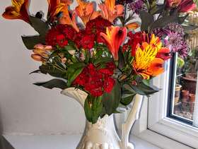 Freecycle Fresh flowers in a china jug decorated with cherubs